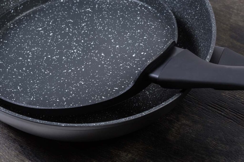 Close up of two frying pans, representing the Brooklyn Steel class action.