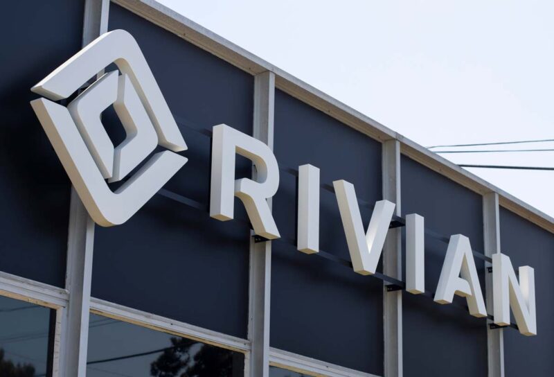 Close up of Rivian dealership signage, representing Rivian investor class action lawsuit.