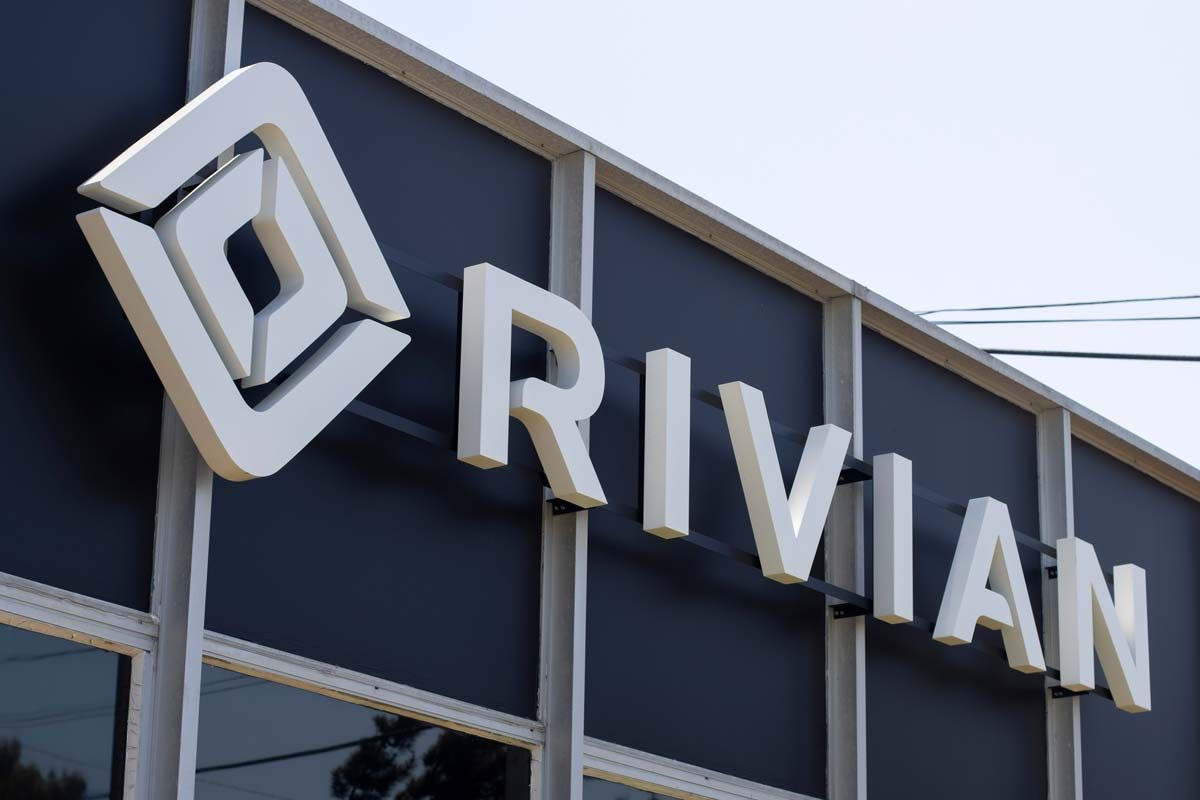 Close up of Rivian dealership signage, representing Rivian investor class action lawsuit.