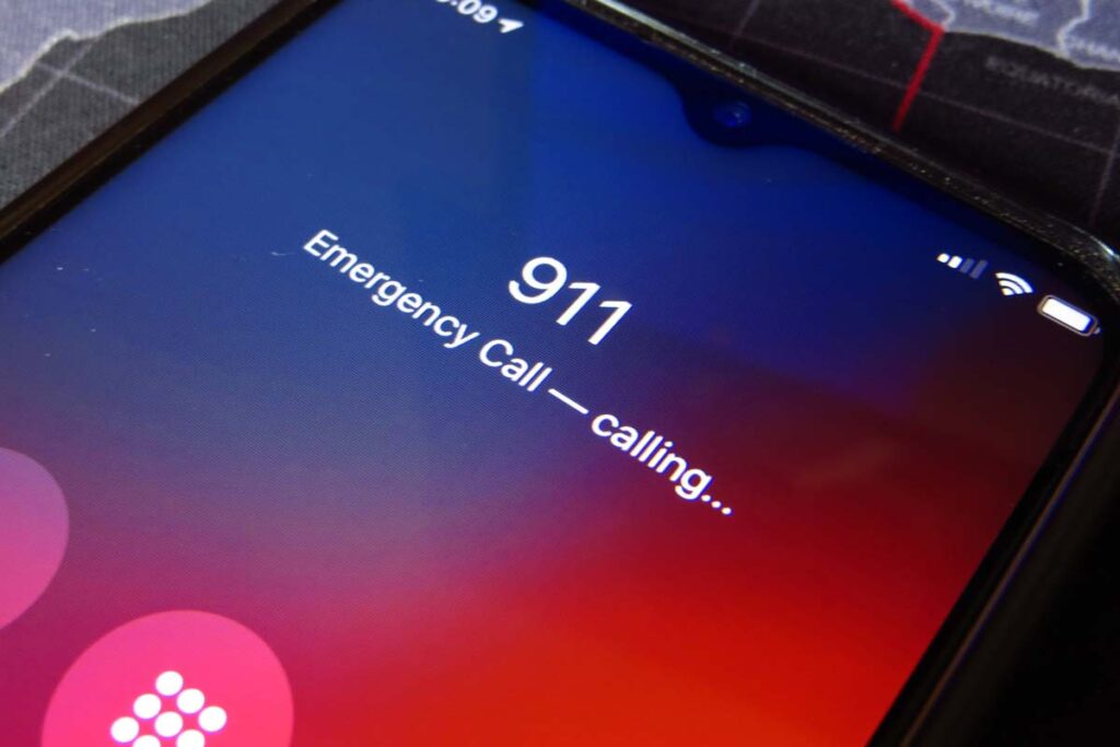 Close up of a smartphone calling 911, representing the 911 outage.