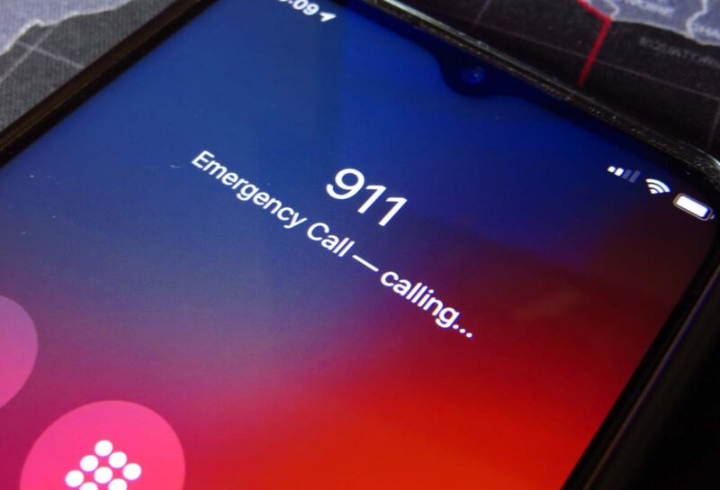 Close up of a smartphone calling 911, representing the 911 outage.