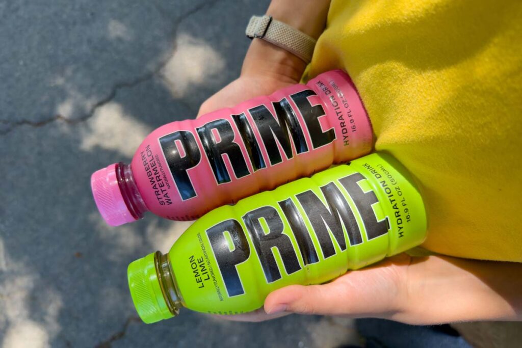 Close up of hands holding Prime Hydration drinks, representing the Prime Hydration class action.
