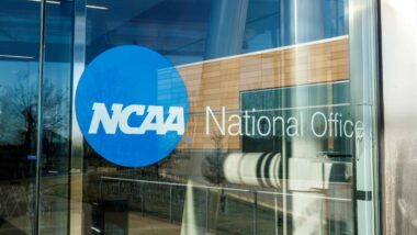 Close up of NCAA National Office signage on a glass door, representing the NCAA NIL lawsuit.