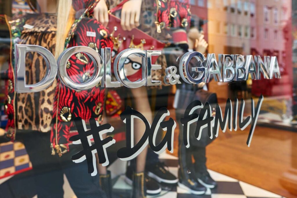 Close up of Dolce & Gabbana signage in a window of a store, representing the Dolce & Gabbana class action.