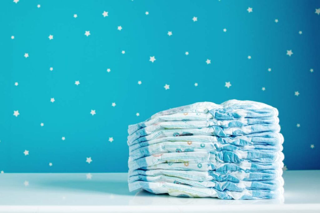 A stack of new diapers in a baby room, representing the Munchkin class action.