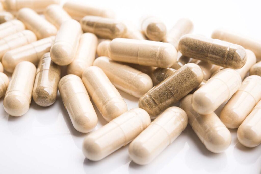 Close up of supplement capsules against a white backdrop, representing Joe Rogan brain health supplements.