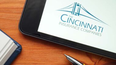Cincinnati Insurance Companies logo displayed on a tablet next to a pen and journal, representing the Cincinnati Insurance settlement.