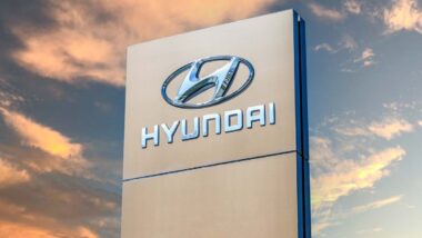 Hyundai signage against a sunset sky, representing the Hyundai settlement.