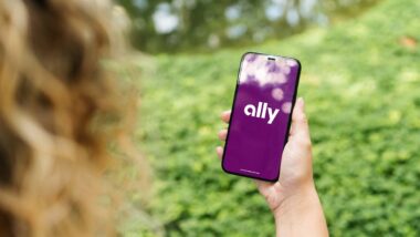 Close up of a woman using a smartphone with the Ally logo displayed, representing the Ally Financial class action.