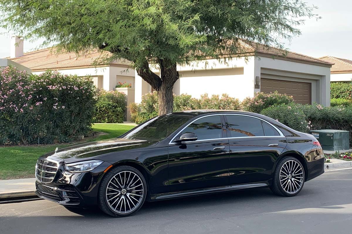 A black Mercedes S580 parked on the side of the road, representing the Mercedes-Benz class action.