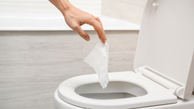 throwing flushable wipe into toilet.