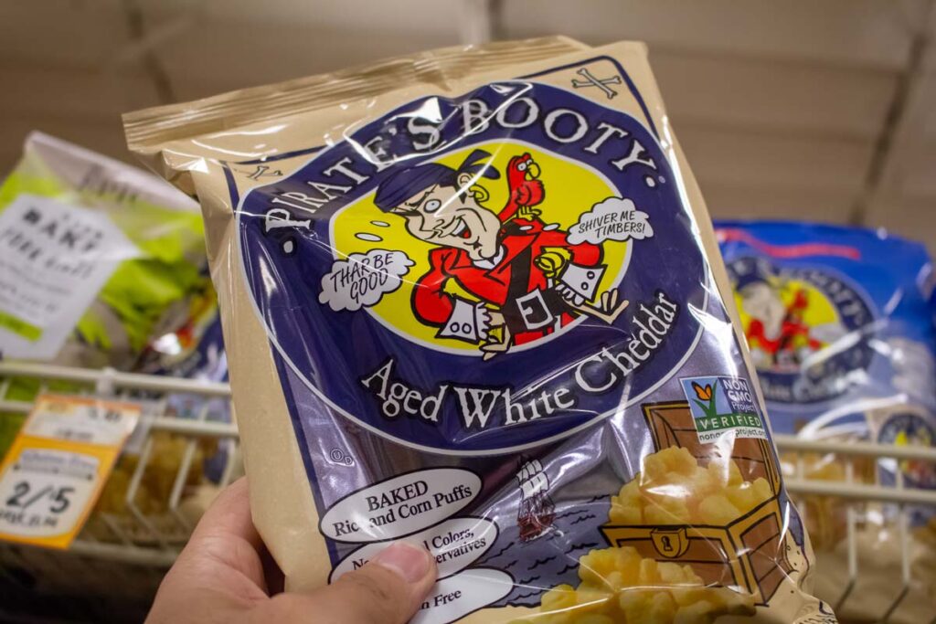Close up of a hand holding a Pirate's Bay snack package, representing the Pirate's Booty class action.