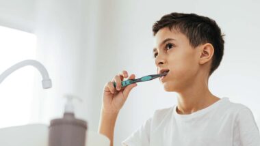 A young boy brushing his teeth, representing the toothpaste PFAS class action.