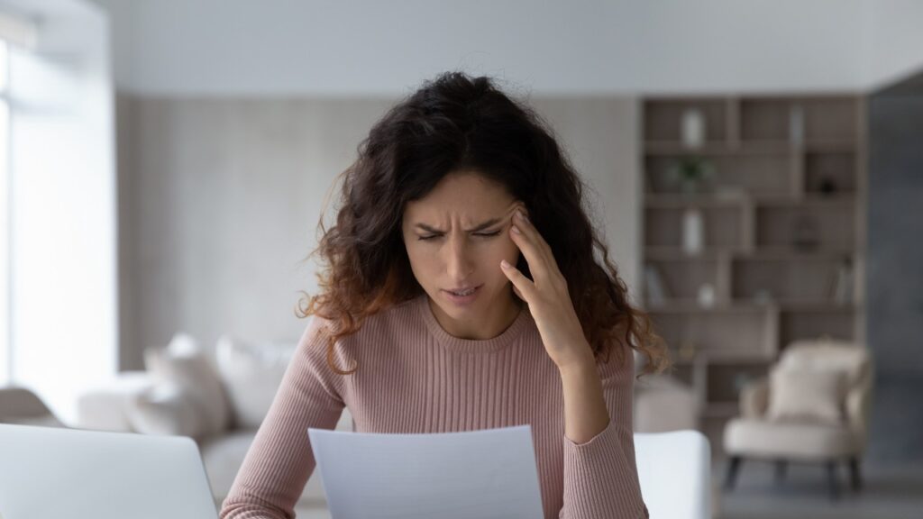 Woman finding confusing information on bad credit report.