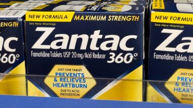 Close up of Zantac products for sale on a supermarket shelf, representing the Zantac lawsuits.
