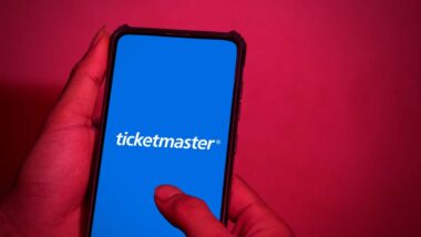 Close up of hands holding a smartphone with Ticketmaster logo displayed, representing the Ticketmaster class action.