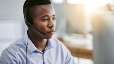 A debt collector wearing a headset while on a phone call, representing the debt collector class action.