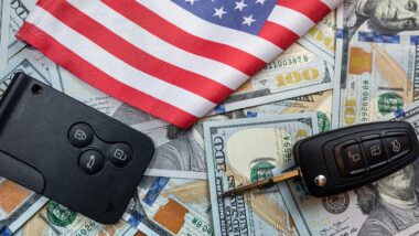 Car's keys on the dollar money and usa flag, finance purchase sale insurance concept