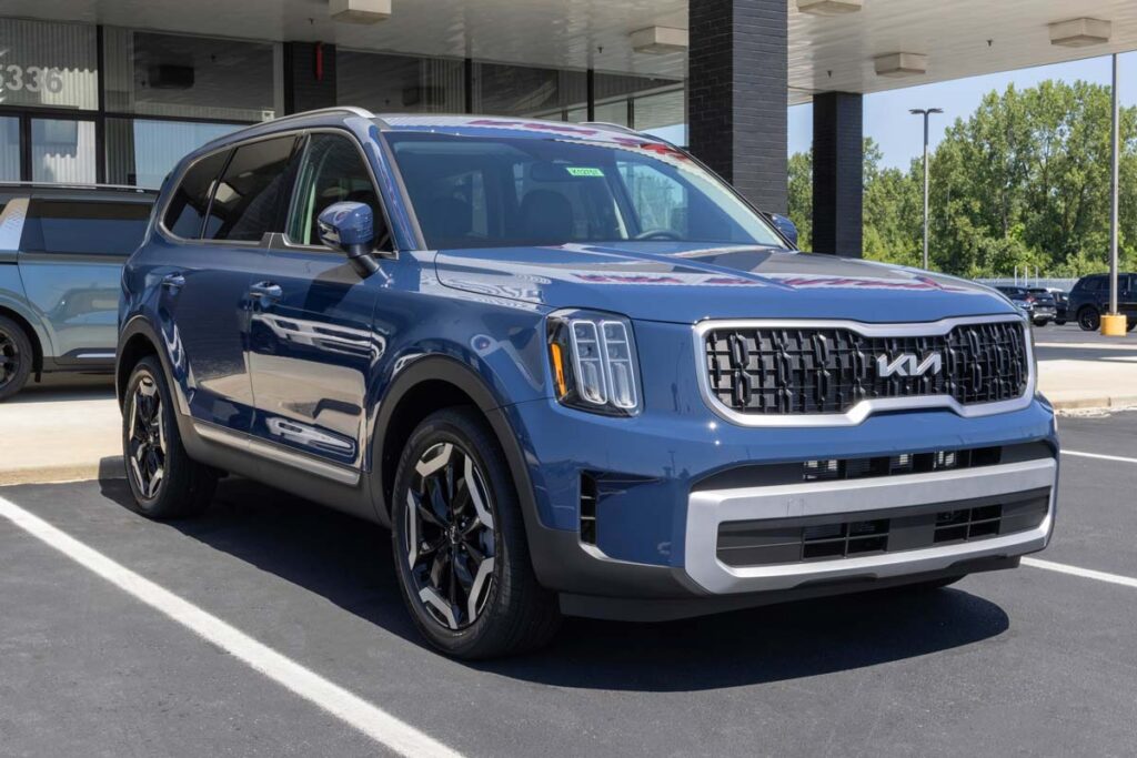 A blue Kia Telluride on display at a dealership, representing the Kia park outside recall.