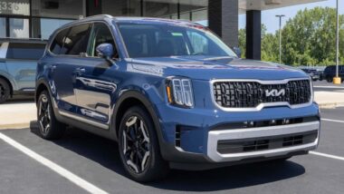 A blue Kia Telluride on display at a dealership, representing the Kia park outside recall.