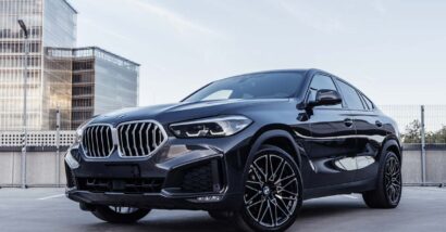 A black BMW X6 on a parking garage rooftop, representing the BMW class action.