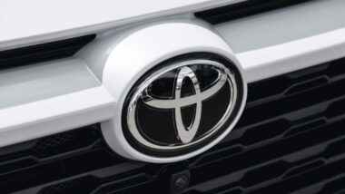 Close up of a Toyota emblem on a front bumper, representing the Toyota recalls.