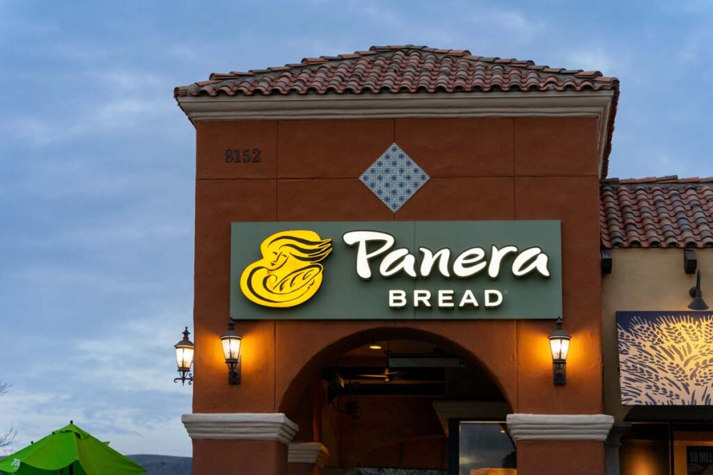 Close up of illuminated exterior Panera Bread signage at dusk, representing the Panera class action.