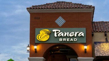 Close up of illuminated exterior Panera Bread signage at dusk, representing the Panera class action.