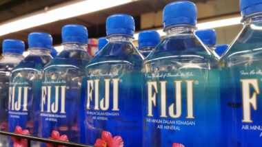 Fiji water bottles on display at a supermarket, representing the Fiji water recall.