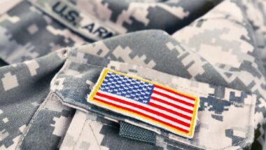 Close up of a U.S. flag patch on an army uniform, representing the veterans and military class actions.