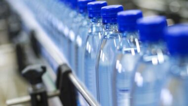 Close up of water bottles on a manufacturing line, representing the Real Water trial.