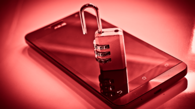 Open lock on top of smart phone, data breach concept.