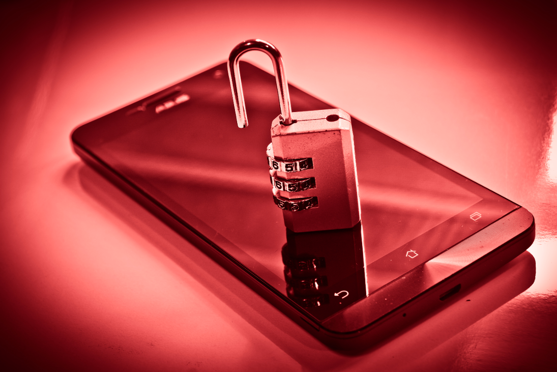 Open lock on top of smart phone, data breach concept.