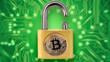Broken padlock with bitcoin logo.