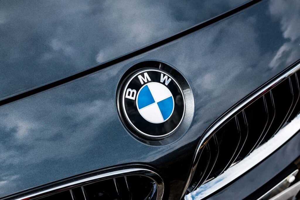 Close up of BMW emblem on a front bumper, representing the BMW recall.