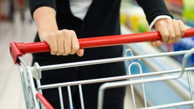 Close up of a womans hands pushing a shopping cart, representing top recalls for the week of June 24.