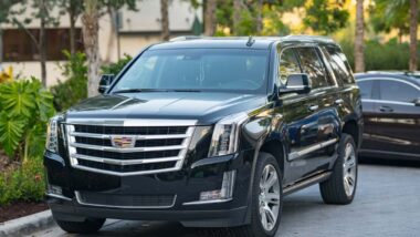 A black Cadillac Escalade parked on a street, representing the GM class action.