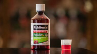 Robitussin bottle on a kitchen counter, representing Robitussin settlement.