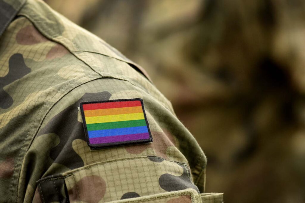 Close up of a rainbow flag patch on a military uniform, representing the LGBTQ vets class action.