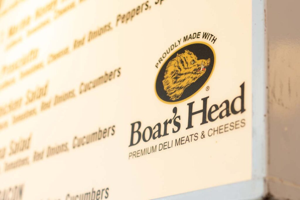 Close up of the Boar's Head logo, representing Boar's head deli meat recall.