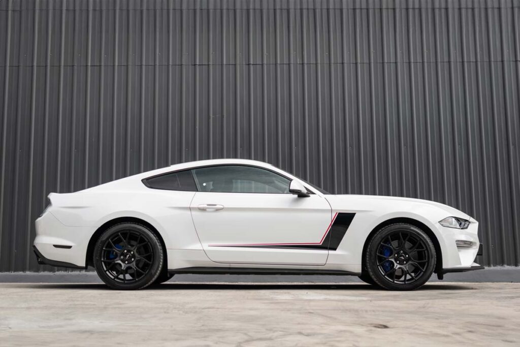 Side view of a white Ford Mustang, representing the Ford Mustang recall.