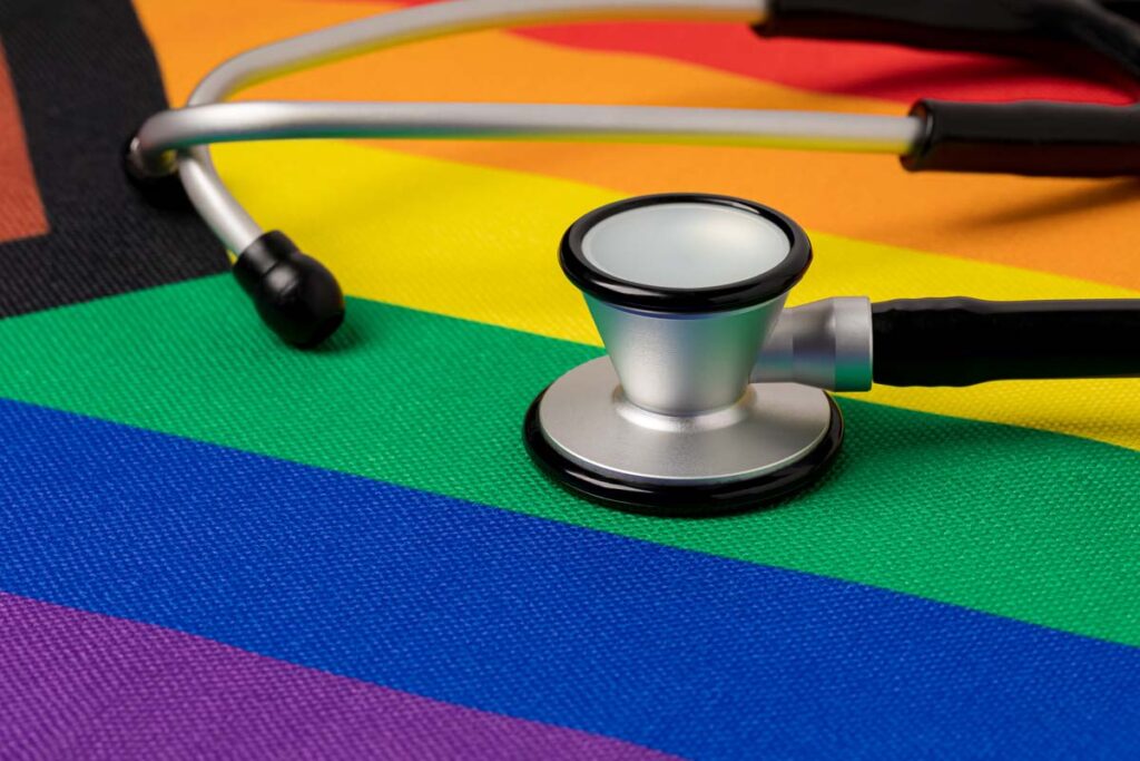 A stethoscope atop a pride flag, representing Premera transgender care class action lawsuit.