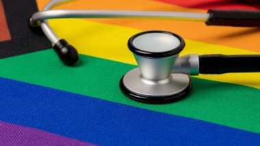 A stethoscope atop a pride flag, representing Premera transgender care class action lawsuit.