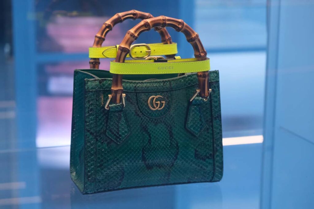 A Gucci handbag made of Python skin in a display case, representing the Gucci class action.