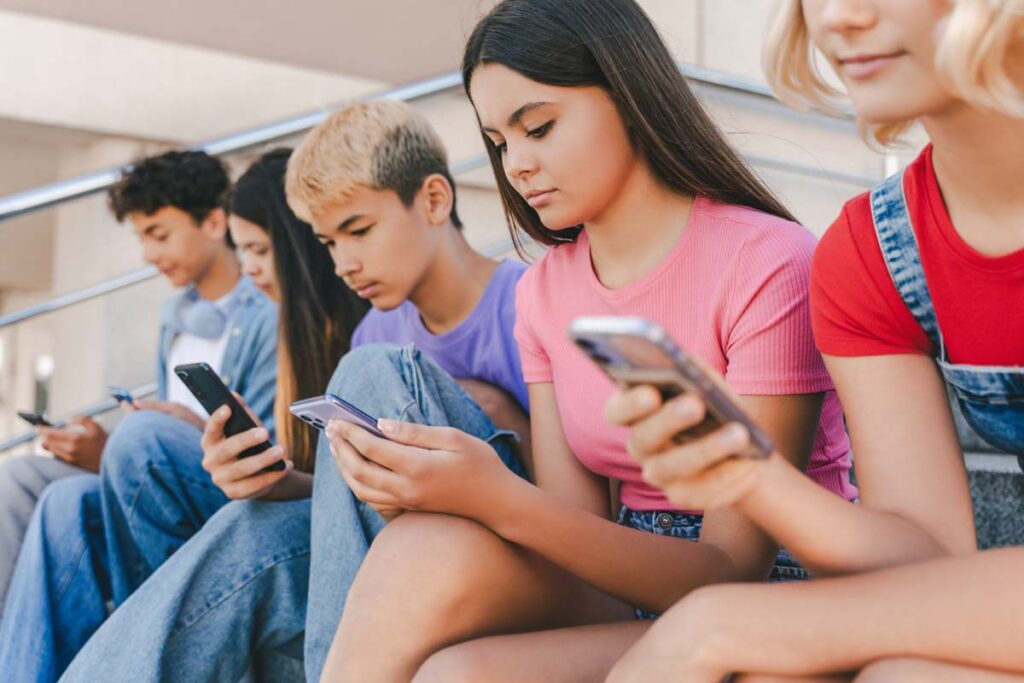 A group of minors using their smartphones, representing the Google class action.