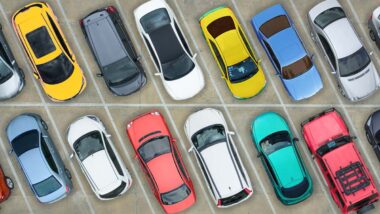 Aerial view of various cars in a lot, representing June auto recalls.