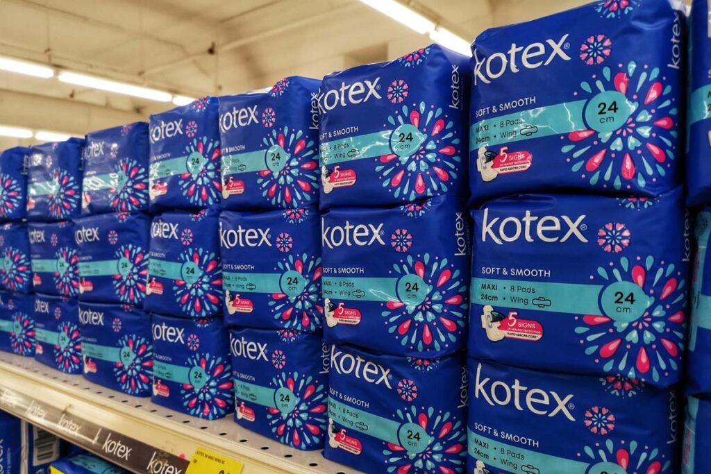 Kotex tampon products on a supermarket shelf, representing the Tampax and Kotex class actions.