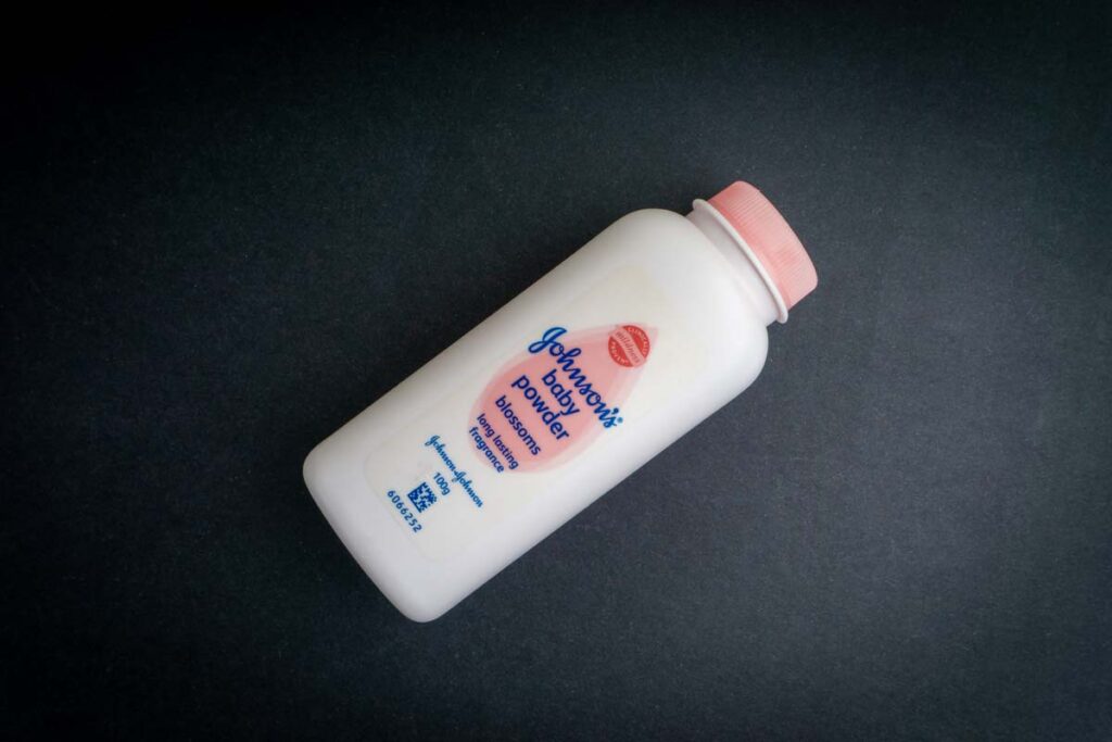 Johnson baby powder against a black backdrop, representing the Johnson & Johnson talc verdict.