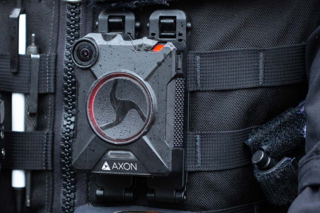 Close up of a police officer wearing an Axon body cam, representing the Axon cameras class action.