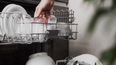 Close up of a woman loading a dishwasher, representing the Frigidaire class action.